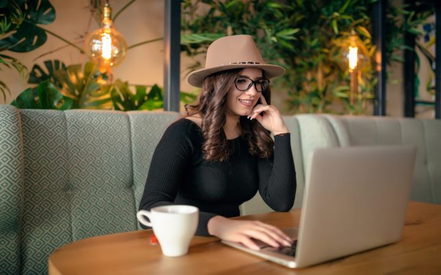 stylish hipster girl using laptop computer.