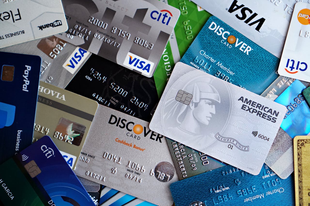A flat lay of assorted credit and debit cards from various banks. Ideal for finance and banking concepts.